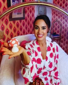 Dr. Shannon Chavez, Beverly Hills sex therapist, smiling while holding the Woo More Play Mushroom Vibez vibrator as a beginner‑friendly intimacy tool