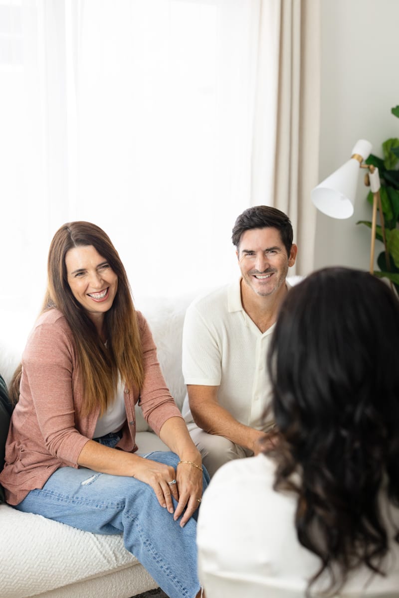 A married couple is seated on a couch during therapy in California.