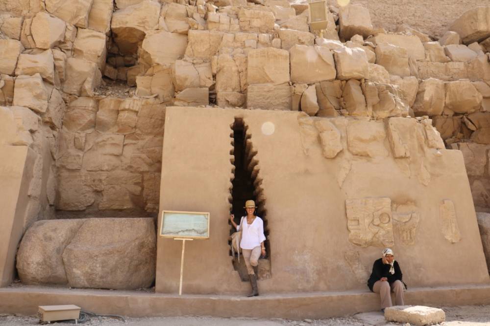 Dr. Shannon Chavez standing at the entrance of an ancient Egyptian burial site in the Valley of the Kings.
